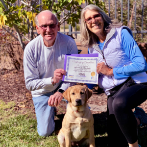 Happy couple showing off their completion certificate